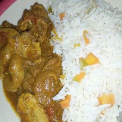 A picture of Rice with chicken curry.