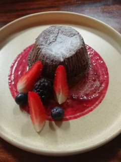 Una foto de Lava cake con salsa de frutos rojos