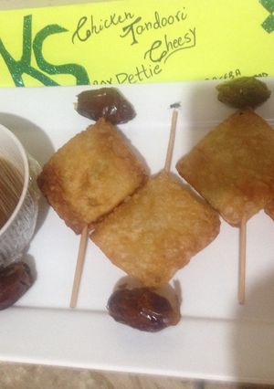 A picture of Chicken tandori cheesy Pettie with imli and khajoor chutney.