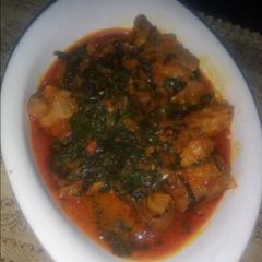 A picture of Tomato stew with scent leaves.