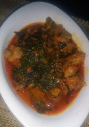 A picture of Tomato stew with scent leaves.