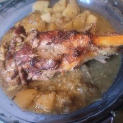 Young Goat Leg with Potatoes, Onions and Gravy A picture of Young Goat Leg with Potatoes, Onions and Gravy.