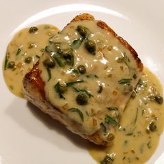 A picture of Pan-seared salmon with white wine and caper sauce.