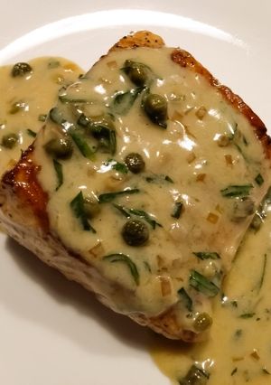 A picture of Pan-seared salmon with white wine and caper sauce.
