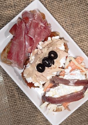 Una foto de Trío de tostadas: bonito, anchoas y jamón