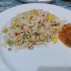 A picture of Chinese rice with nuggets jalfrezi.