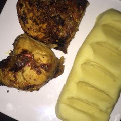 A picture of Mashed potatoes & grilled chicken.