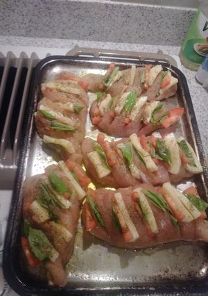 A picture of Stuffed chicken witb basil mozzarella and tomato.