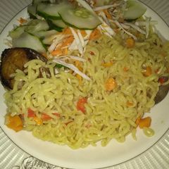 A picture of Veggies indomie with fried fish.