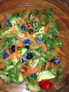 A picture of Citrus avocado and arugula salad with fresh ginger.
