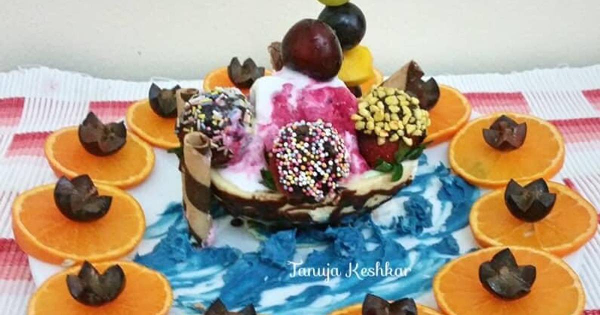 Chocolate boat with mixed fruit ice cream and chocolate dry fruits