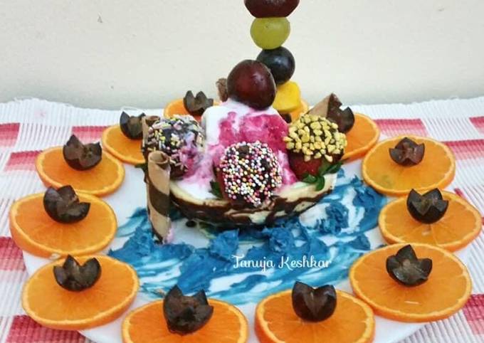 Chocolate boat with mixed fruit ice cream and chocolate dry fruits balls