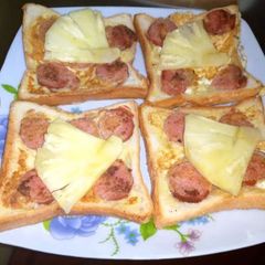 A picture of French toast with sausages.