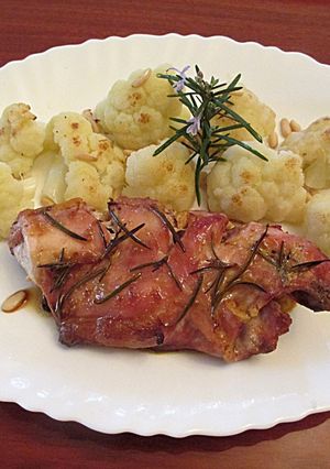 Foto principal de Conejo al romero al horno con guarnición