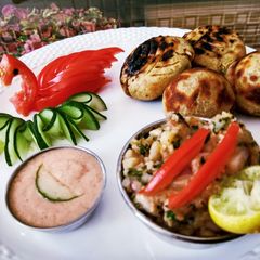 A picture of Litti chokha with smokey tomato chutney.