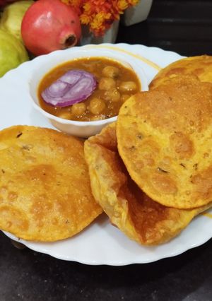 A picture of Punjabi Thali - Chana Masala Curry with Methi Masala Puri.
