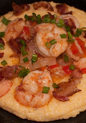 A picture of Shrimp and cheesy grits with bacon.
