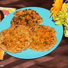 A picture of Rava Carrot Uttappam / South Indian Style Grilled Semolina Pancakes Topped With Carrots.