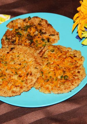 A picture of Rava Carrot Uttappam / South Indian Style Grilled Semolina Pancakes Topped With Carrots.