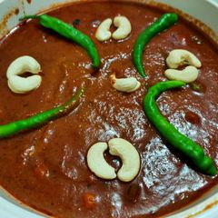 A picture of Cashew capsicum and peas curry Restaurant style.