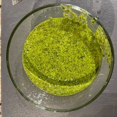 A picture of Roasted chicken spaghetti squash and pesto.