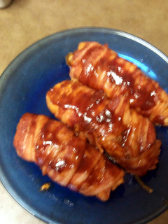 A picture of stuffed bacon wrapped barbeque chicken.