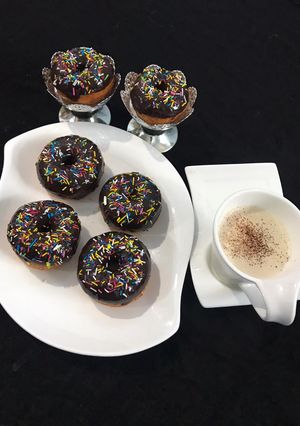 A picture of Chocolate Donuts 🍩 With Capachino Coffee.