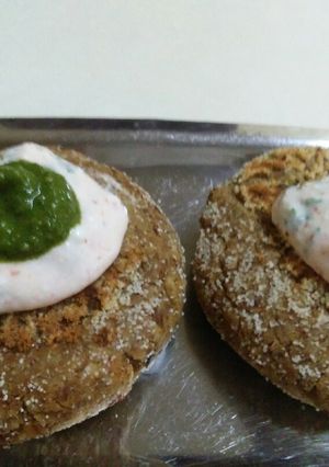 A picture of Black Chana cutlet topped with hung curd and coriander mint chutney.
