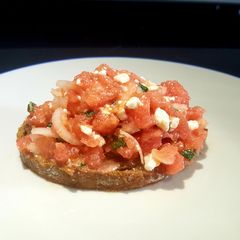 A picture of Bruschetta with a watermelon, feta and mint salsa.