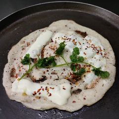 Owar cheese pizza dosa with tomato onion chutney gravy A picture of Owar cheese pizza dosa with tomato onion chutney gravy.