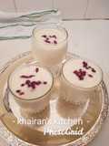 Pineapple and banana smoothie with pomegranate seeds on top
