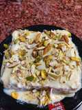 Bread sponge wrapped with rabdi and nuts sauce