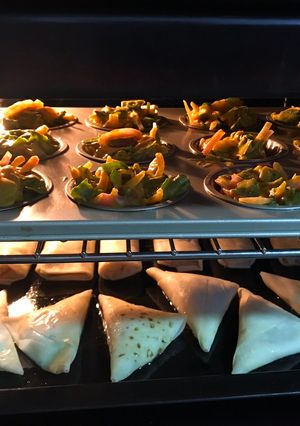 A picture of Oven baked samosas and rolls.