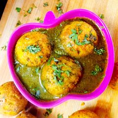 A picture of Moong dal Dumplings In Spinach Tomato soup.