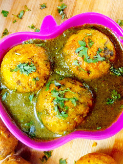 A picture of Moong dal Dumplings In Spinach Tomato soup.