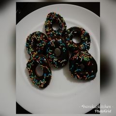 A picture of Cardamon donuts with chocolate glaze.