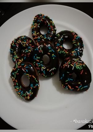 A picture of Cardamon donuts with chocolate glaze.
