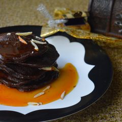 A picture of Chocolate Malpua with Orange Caramel Sauce.