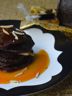 A picture of Chocolate Malpua with Orange Caramel Sauce.