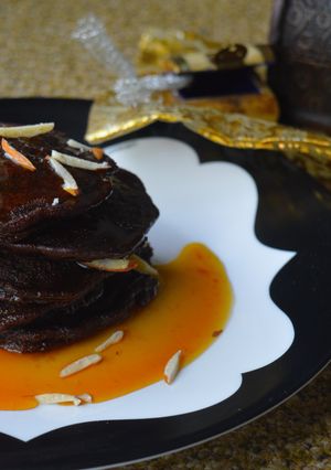 A picture of Chocolate Malpua with Orange Caramel Sauce.