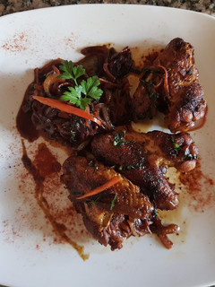 Una foto de Alitas de pollo, con vegetales caramelizados
