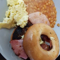 A picture of My Buttered toasted Bagel with Bacon,scrambled Egg + Beans. 💖.