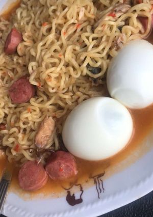 A picture of Noodles with sausage rolls and sardine.