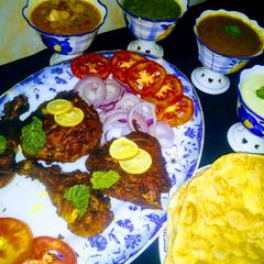 A picture of Chicken tikka /paratha with aloo ki tarkari.