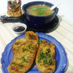 A picture of Garlic bread with soup.