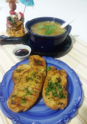 A picture of Garlic bread with soup.