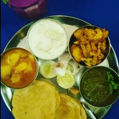 A picture of Aloo Platter Aloo Gobhi AlooTamatar Aloo Raita Puri Chutney.