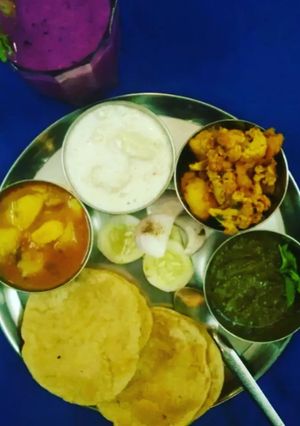 A picture of Aloo Platter Aloo Gobhi AlooTamatar Aloo Raita Puri Chutney.