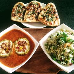 A picture of Matar Paneer Koftas, tawa coriander naan with methi matar pulao.