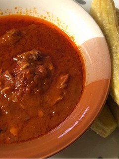 A picture of Tomatoes stew with boiled plantaini.